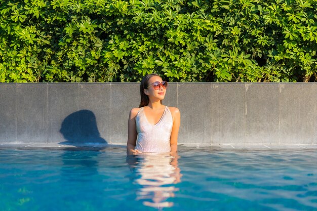 Portrait of beautiful young woman relaxing at the swimming pool