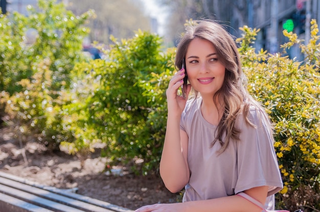 Portrait of beautiful young woman using her mobile phone in the