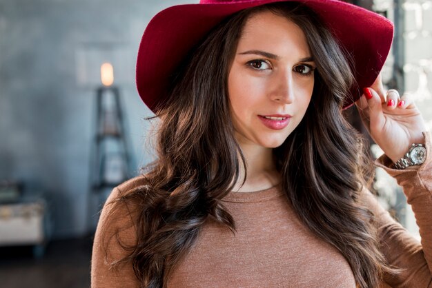 Portrait of a beautiful young woman wearing hat looking at camera