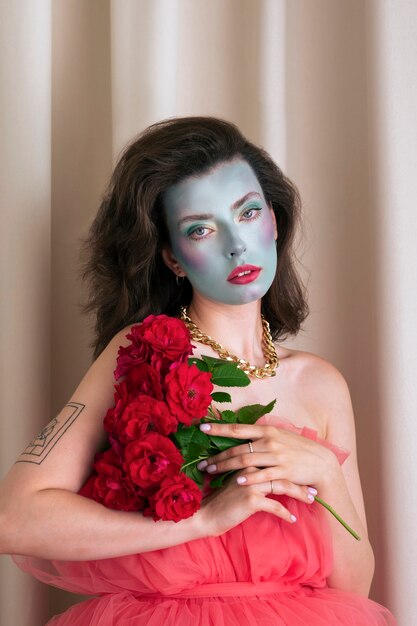 Portrait of beautiful young woman with face paint and flowers