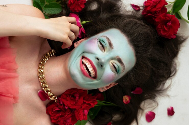 Free Photo portrait of beautiful young woman with face paint and flowers