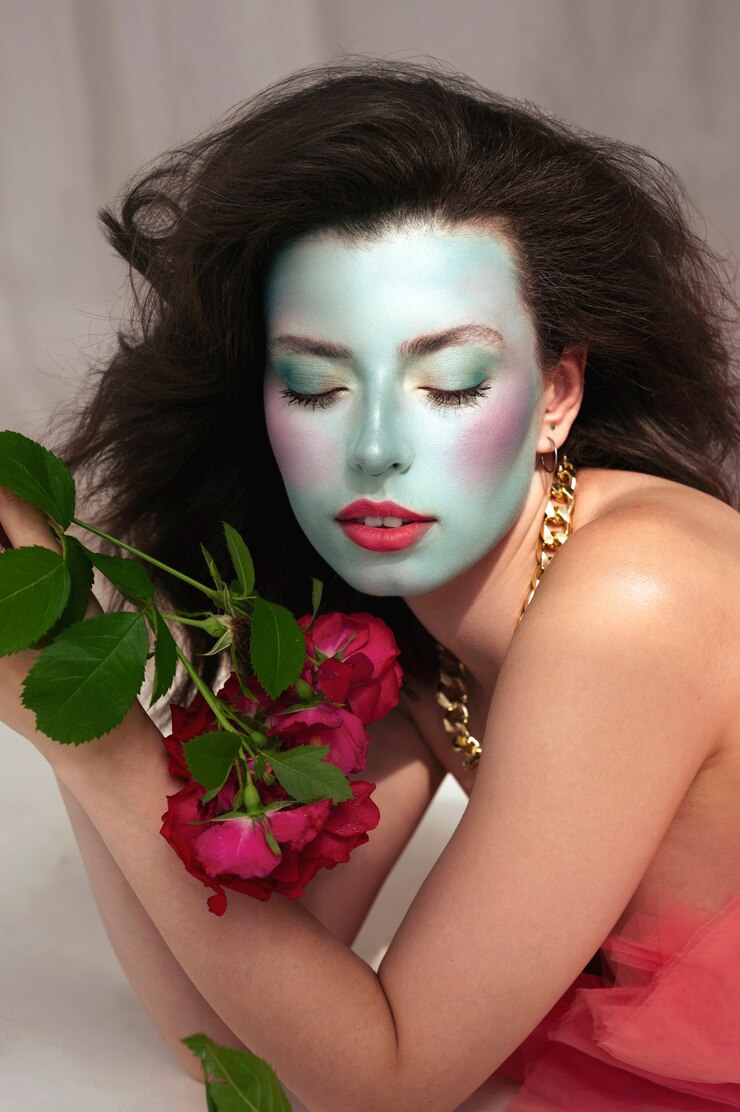 Free Photo portrait of beautiful young woman with face paint and flowers