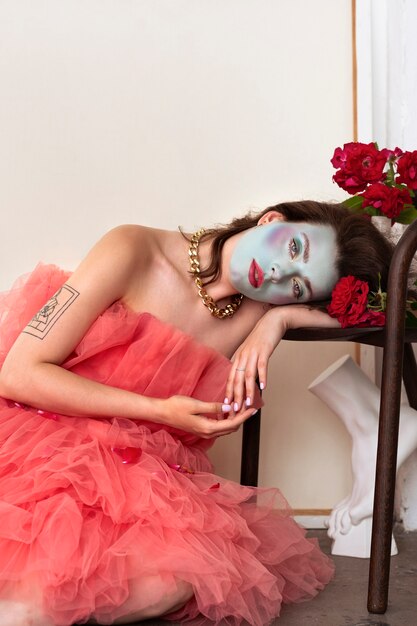 Portrait of beautiful young woman with face paint and flowers