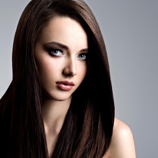 Portrait of beautiful young woman with long straight  hair 