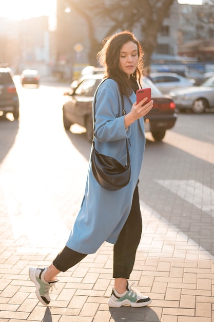 Portrait of beautiful young woman with mobile phone