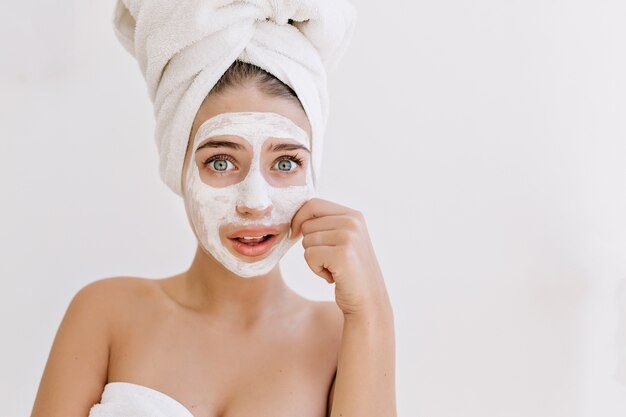 Portrait of beautiful young woman  with towels after take bath make cosmetic mask and worries about her skin.