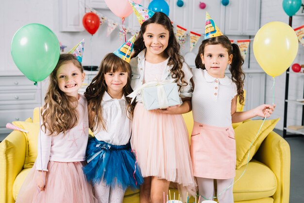 Portrait of a birthday girl with her friends in the party