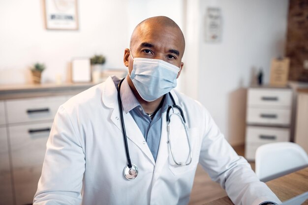 Portrait of black doctor working at his office during coronavirus pandemic