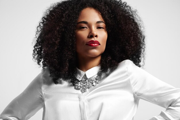 Portrait of black woman looking at camera with afro hair