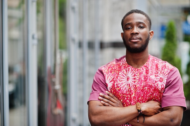 Portrait of a black young man wearing african traditional red colorful clothes