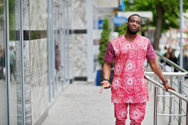 Portrait of a black young man wearing african traditional red colorful clothes