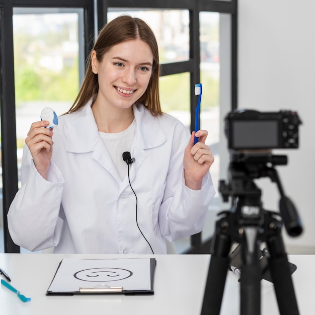 Portrait of blogger presenting dental accessories