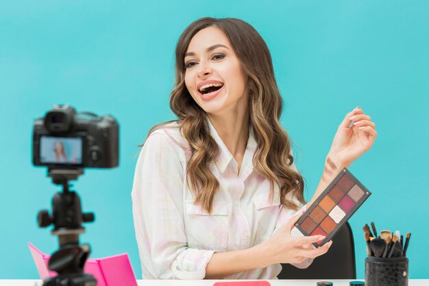 Portrait of blogger trying out make-up products