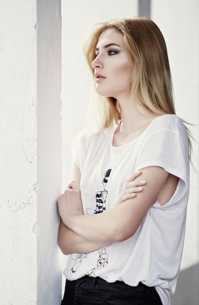 Portrait of blond sexy woman in a white t shirt.