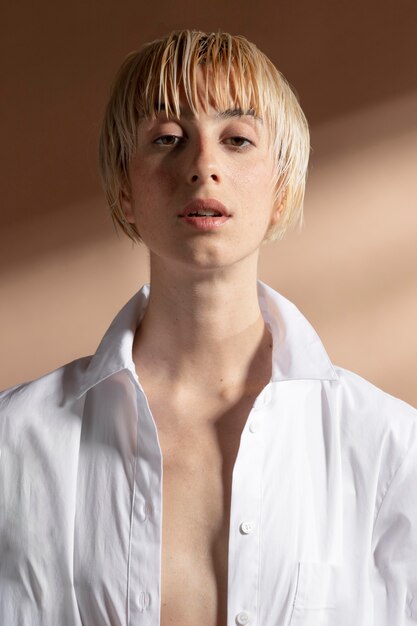 Portrait of blonde short-haired woman posing in a white shirt