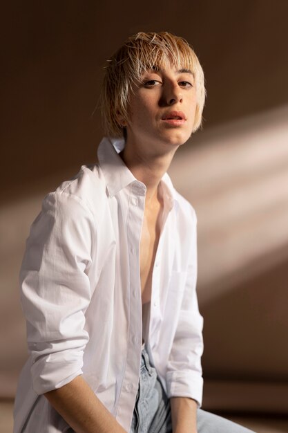 Portrait of blonde short-haired woman posing in a white shirt