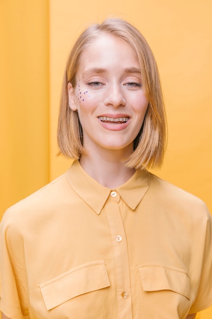 Portrait of blonde woman in a yellow scene