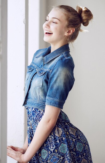 Portrait of a blue eyed blond female dressed in a denim jacket.