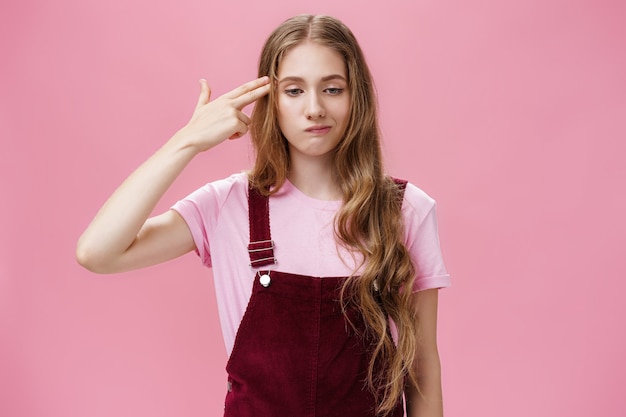 Portrait of bothered uneasy cute european female with long natural fair hair in trendy corduroy over...