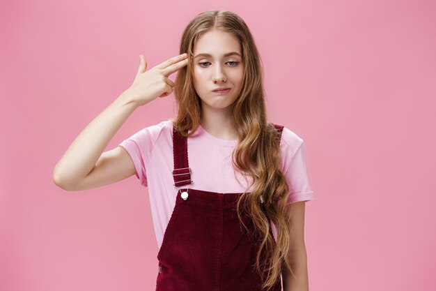 Portrait of bothered uneasy cute european female with long natural fair hair in trendy corduroy over...