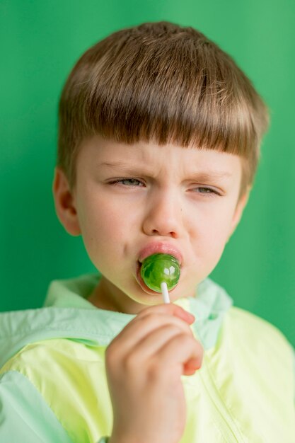 Portrait boy eating lollipop