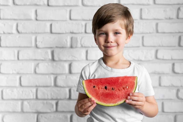 Portrait boy eating watermelon