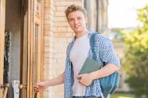 Free photo portrait of boy in front of school