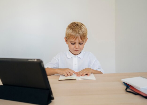 Portrait of a boy paying attention to online class