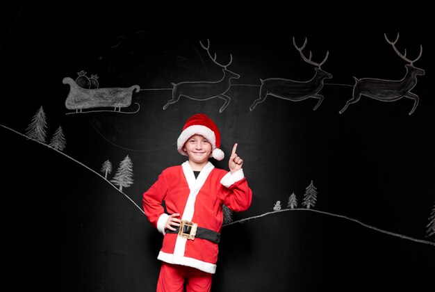 Portrait of boy in santa claus costume