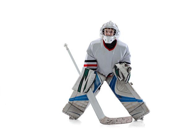 Portrait of boy teenager hockey player training in special protective uniform isolated over white studio background