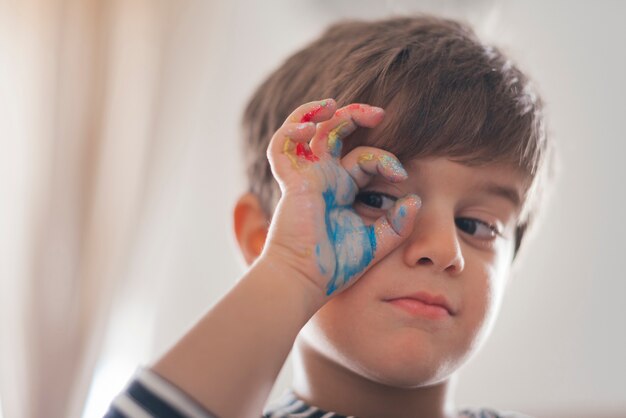 Portrait of boy with paint on hand