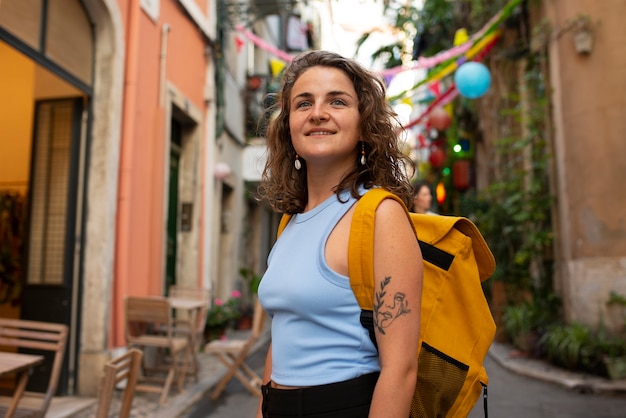 Portrait of braless woman outdoors with backpack