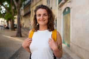 Free photo portrait of braless woman outdoors with backpack