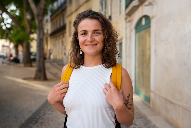 Portrait of braless woman outdoors with backpack