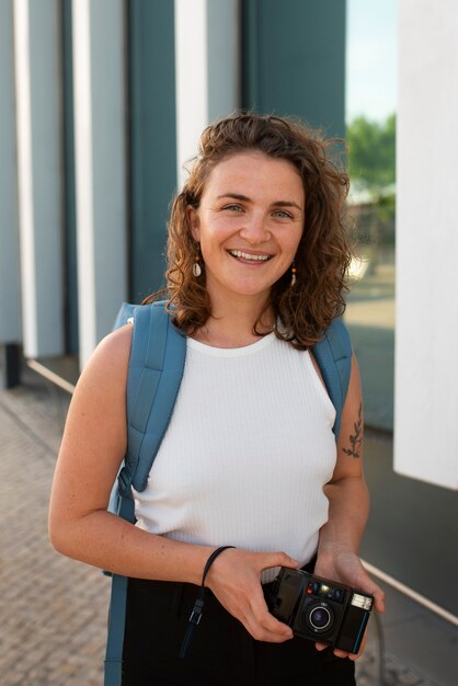 Portrait of braless woman outdoors with camera