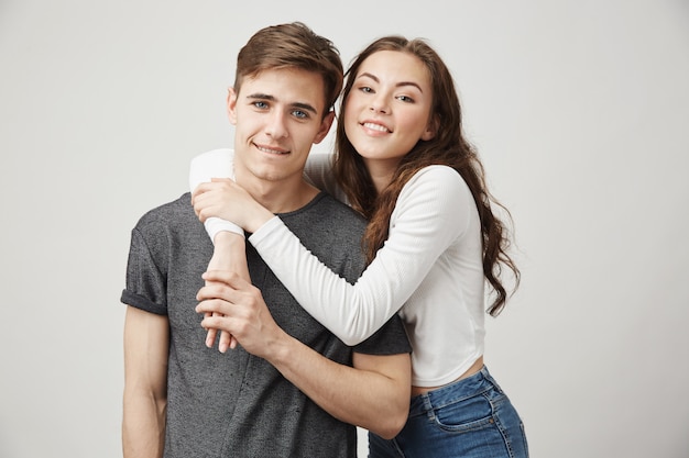 Portrait of brother and sister hugging and smiling