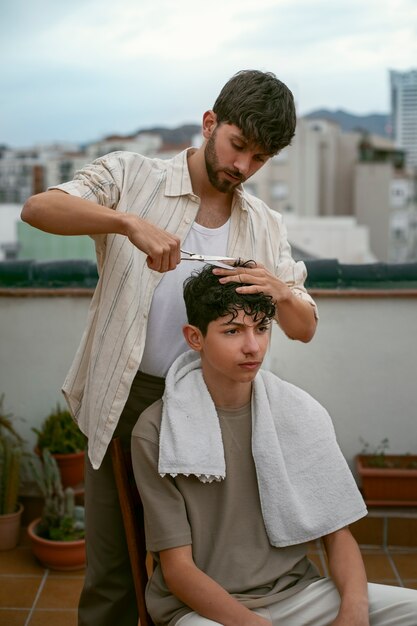 Portrait of brothers outdoors during a haircut session