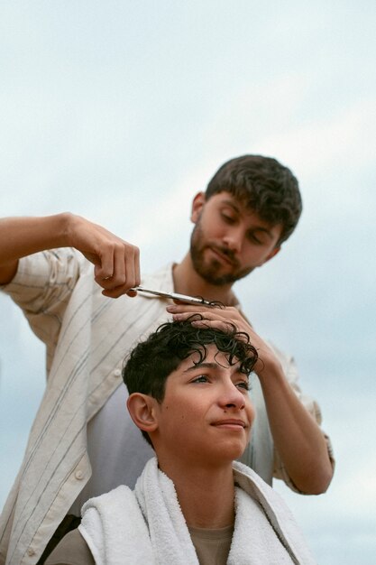 Portrait of brothers outdoors during a haircut session