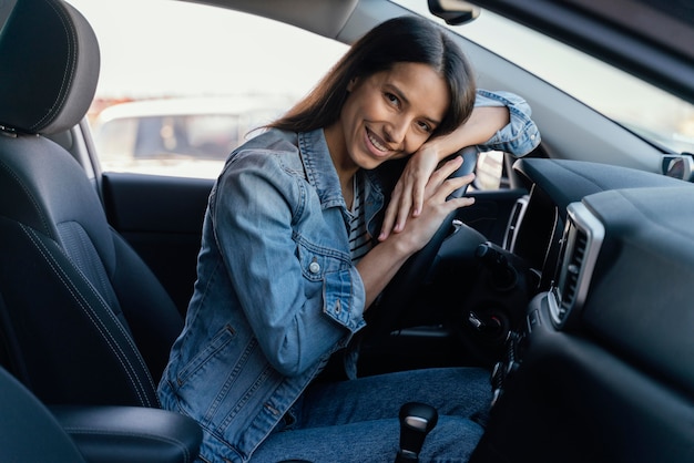 Portrait of brunette woman in her car