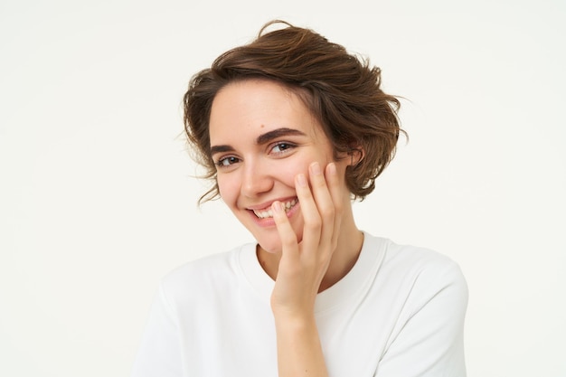 Free photo portrait of brunette woman laughing smiling and covering face with hand looking shy and cute