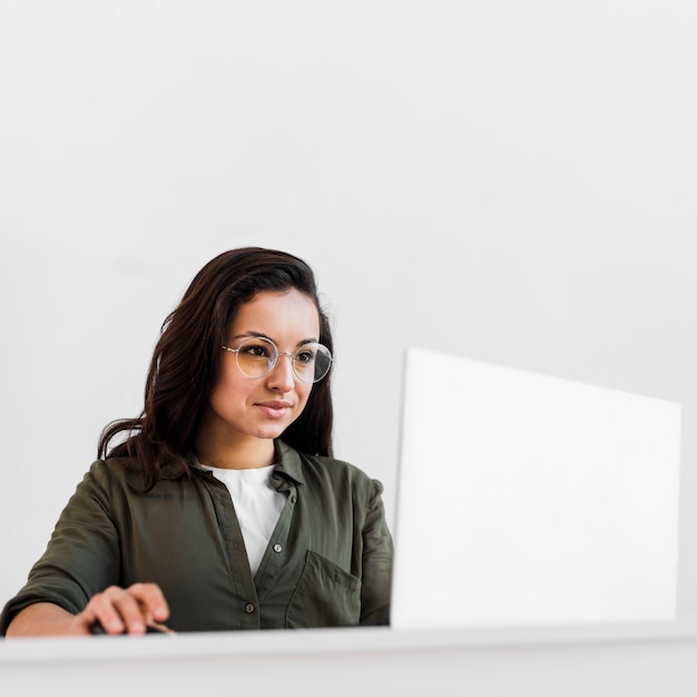 Portrait of brunette woman with eyeglasses working