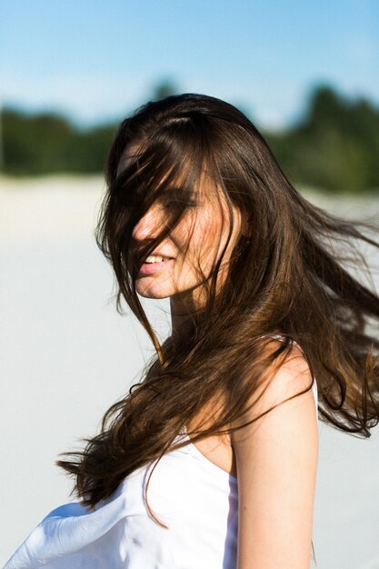 Portrait of brunette woman with long shiny hair