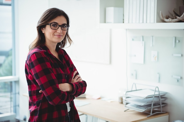 Portrait of business executive standing with arms crossed