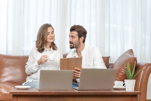 Free photo portrait  businessman and  business woman using the computer laptop at home office