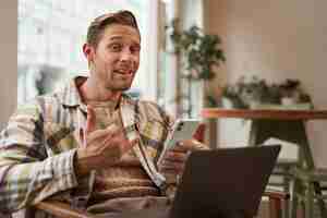 Free photo portrait of businessman making phone call hand sign looking bossy and arrogant working in cafe on