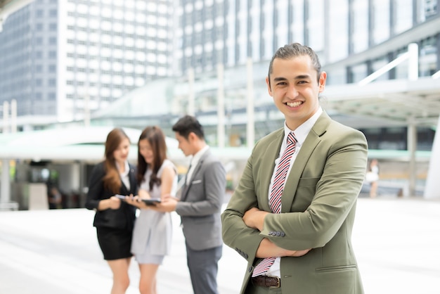 Portrait of Businessman standing against the building outdoors.