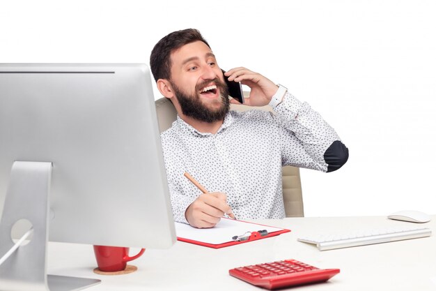 Portrait of businessman talking on mobile phone in office