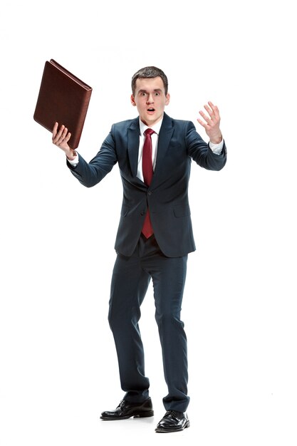 Portrait of businessman with folder on white wall
