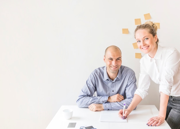 Portrait of businesswoman and businessman working in the office