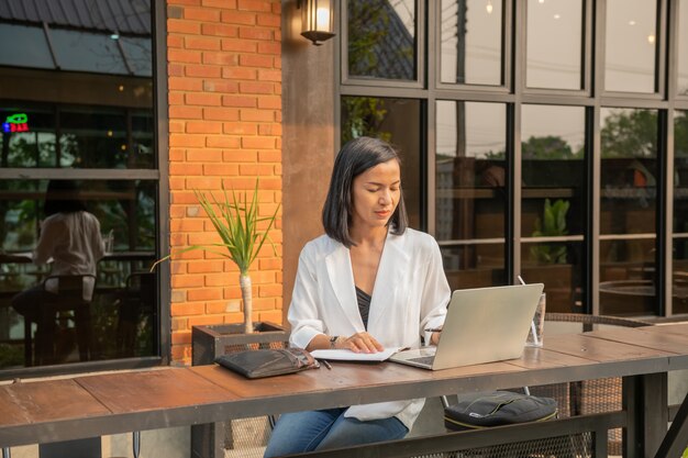 Портрет деловой женщины в кафе с помощью ноутбука
